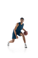 Image showing Young arabian basketball player of team in action, motion isolated on white background. Concept of sport, movement, energy and dynamic.