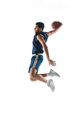 Image showing Young arabian basketball player of team in action, motion isolated on white background. Concept of sport, movement, energy and dynamic.