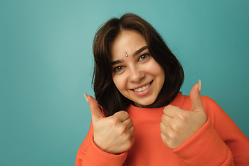 Image showing Caucasian woman\'s portrait isolated on blue studio background with copyspace