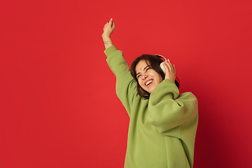 Image showing Caucasian woman\'s portrait isolated on red studio background with copyspace