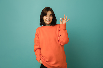 Image showing Caucasian woman\'s portrait isolated on blue studio background with copyspace