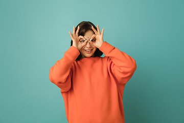 Image showing Caucasian woman\'s portrait isolated on blue studio background with copyspace