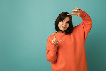 Image showing Caucasian woman\'s portrait isolated on blue studio background with copyspace