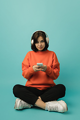 Image showing Caucasian woman\'s portrait isolated on blue studio background with copyspace