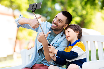 Image showing father and son taking selfie with phone at park