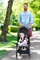 Image showing happy father with child in stroller at summer park