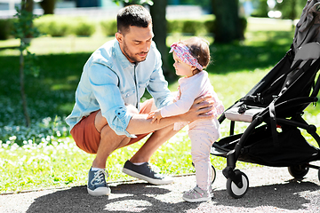 Image showing happy father with child in stroller at summer park