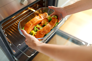 Image showing woman cooking food in oven at home kitchen