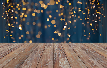 Image showing empty wooden table with christmas golden lights