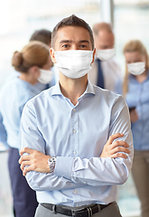 Image showing businessman wearing face protective mask at office