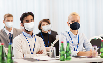 Image showing business people in masks at worldwide conference