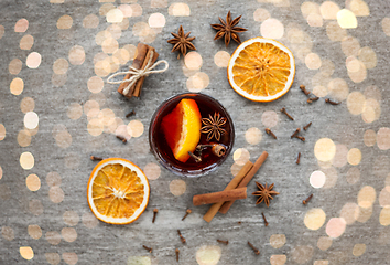 Image showing hot mulled wine, orange slices, raisins and spices