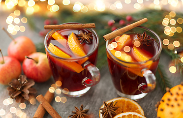 Image showing glass of hot mulled wine, cookies, apples and fir