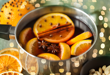 Image showing pot with hot mulled wine, orange slices and spices