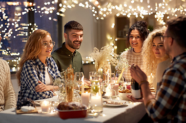 Image showing happy friends with red wine at christmas party