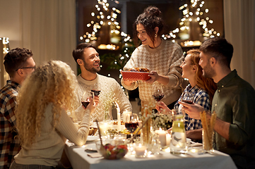 Image showing happy friends having christmas dinner at home