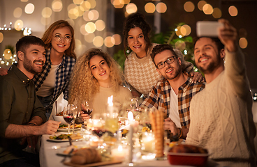 Image showing friends taking selfie at christmas dinner party