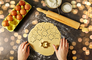 Image showing hands with shortcrust pastry dough and star mold