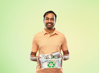 Image showing smiling young indian man sorting metallic waste