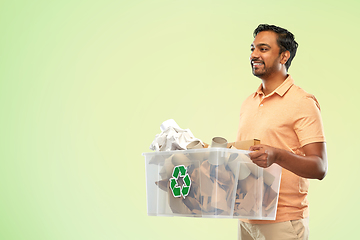 Image showing smiling young indian man sorting paper waste