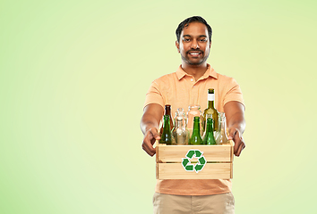 Image showing smiling young indian man sorting glass waste