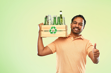 Image showing smiling young indian man sorting glass waste