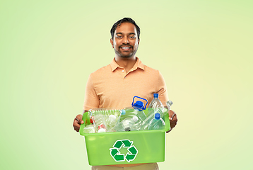 Image showing smiling young indian man sorting plastic waste