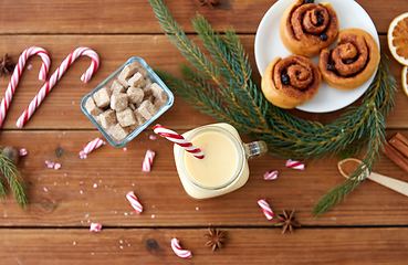 Image showing eggnog with candy cane in mug and cinnamon buns