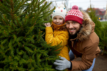 Image showing happy family choosing christmas tree at market