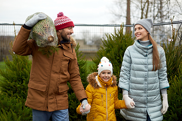 Image showing happy family buying christmas tree at market