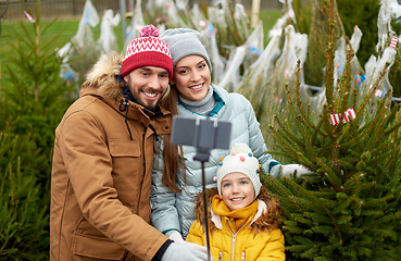 Image showing family taking selfie with christmas tree at market