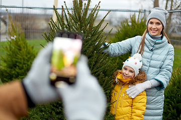 Image showing family taking picture of christmas tree at market