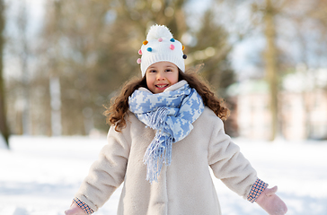 Image showing happy little girl in winter clothes outdoors