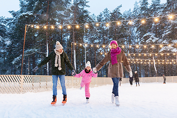 Image showing happy family at outdoor skating rink in winter