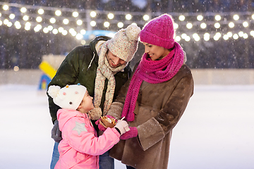 Image showing happy family eating pancakes on skating rink