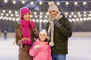Image showing happy family eating pancakes on skating rink