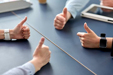 Image showing close up of business team showing thumbs up