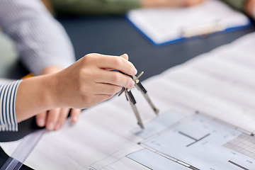 Image showing architect with blueprint and drafting compass