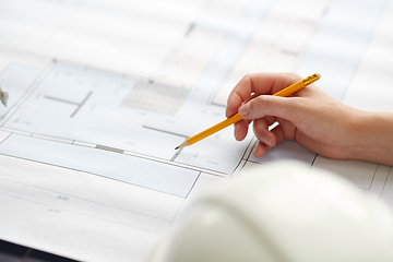 Image showing architect with blueprint working at office