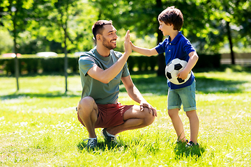 Image showing father giving five to son with soccer ball at park