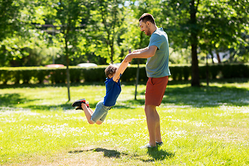 Image showing happy father with son playing in summer park