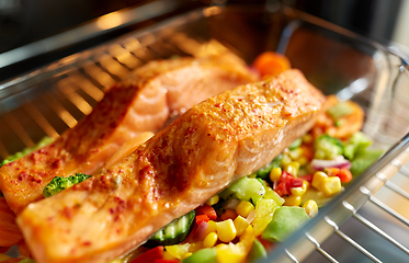 Image showing food cooking in baking dish in oven at home