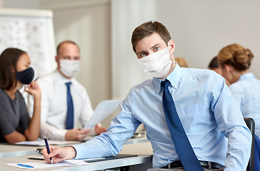 Image showing businessman wearing face protective mask at office