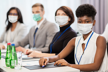 Image showing business people in masks at conference