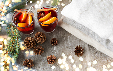 Image showing mulled wine with orange and spices, cones and fir