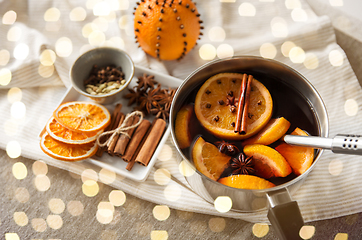 Image showing pot with hot mulled wine, orange slices and spices