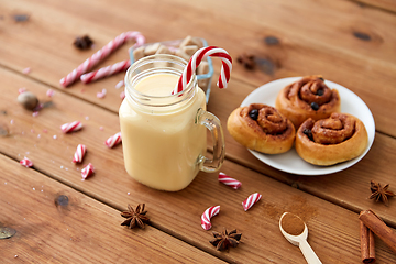 Image showing eggnog with candy cane in mug and cinnamon buns