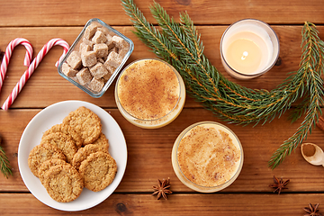 Image showing glasses of eggnog, oatmeal cookies and fir branch