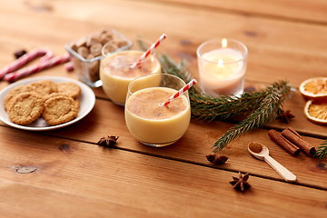 Image showing glasses of eggnog, oatmeal cookies and fir branch