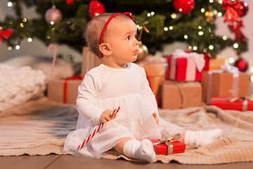 Image showing baby girl at christmas tree with gifts at home